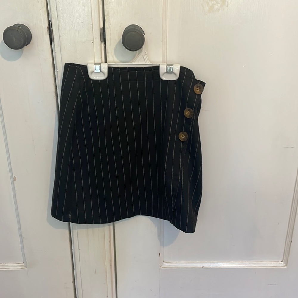 Mid rise black and white stripe skirt with a button up on the side.